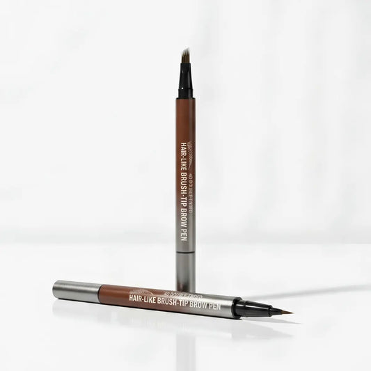A dual-ended hair-like brush-tip brown pen shown standing upright and lying horizontally on a clean white background. The pen barrel is medium brown with silver metal ends and white printed text reading 'HAIR-LIKE BRUSH-TIP BROW PEN' and 'VIVID LANE'.